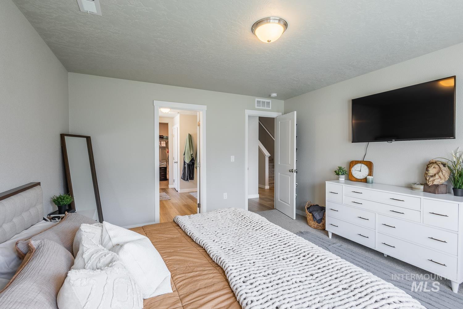 12623 Shadow Peak Street Caldwell, ID 83607 - Photo 27 of 50 Bedroom featuring neutral wall tones, white trim, and a ceiling-mounted light fixture