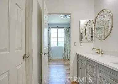 a view of a room with wooden floor and closet area