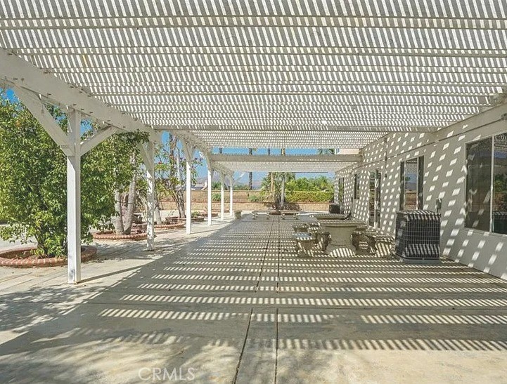 12683 Palm View Way Riverside, CA 92503 - Photo 25 of 25 a view of a patio with a table chairs and floor to ceiling window