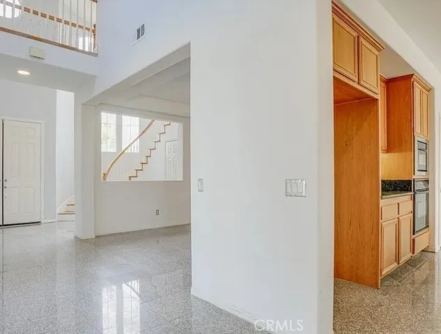 a kitchen with granite countertop stainless steel appliances a sink stove and cabinets