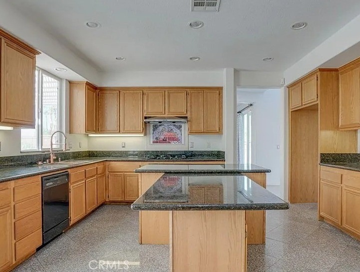 12683 Palm View Way Riverside, CA 92503 - Photo 6 of 25 a kitchen with granite countertop stainless steel appliances a sink stove and cabinets