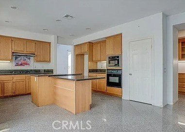 12683 Palm View Way Riverside, CA 92503 - Photo 7 of 25 a kitchen with stainless steel appliances granite countertop a refrigerator and a stove top oven