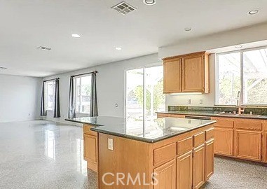 12683 Palm View Way Riverside, CA 92503 - Photo 8 of 25 a large kitchen with granite countertop a sink and cabinets