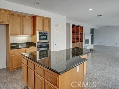 12683 Palm View Way Riverside, CA 92503 - Photo 9 of 25 a kitchen with stainless steel appliances granite countertop a sink and dishwasher a refrigerator with wooden cabinets