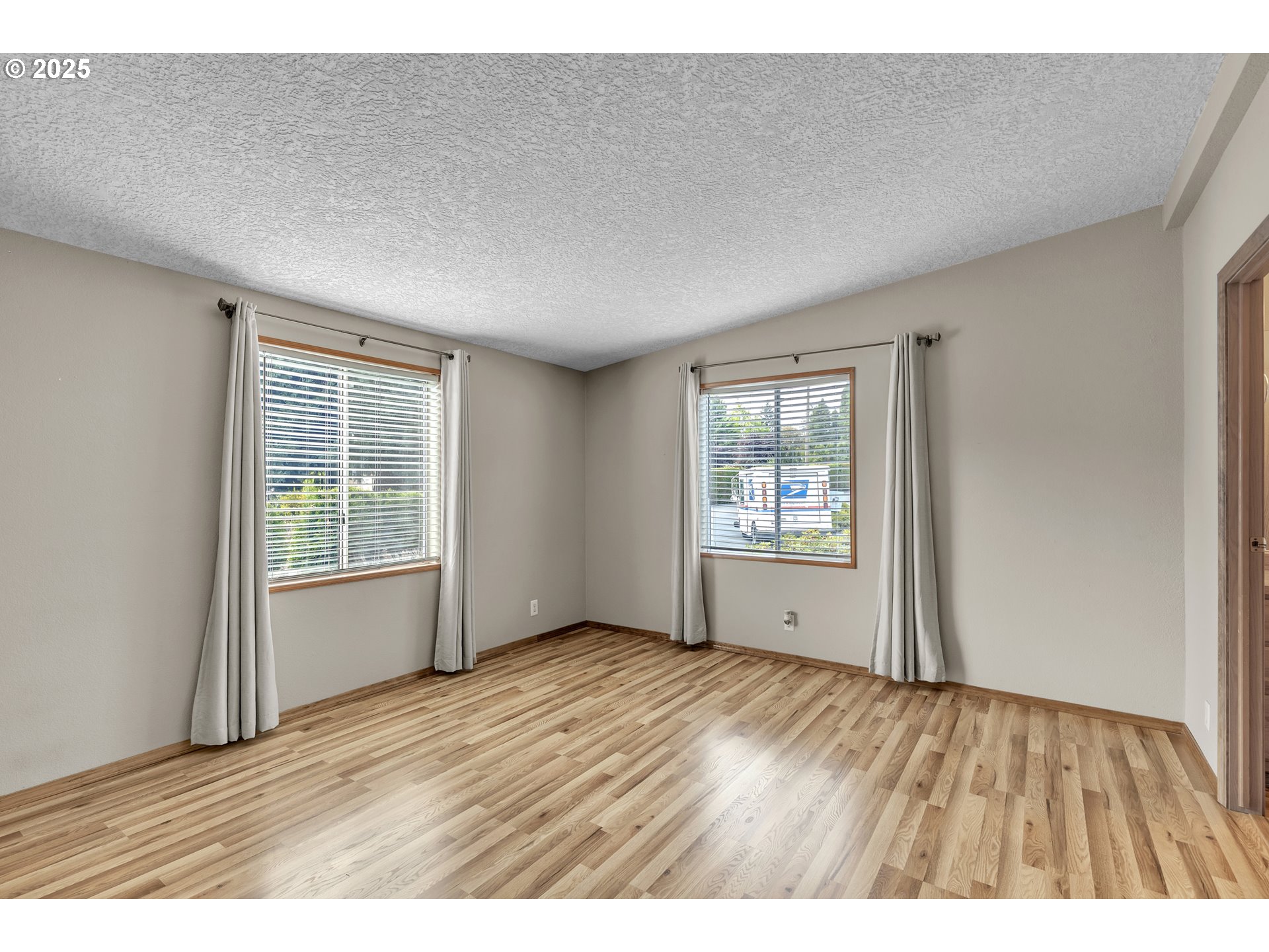 5701 Northeast St Johns Road, Unit 4 Vancouver, WA 98661 - Photo 11 of 28 a view of an empty room with wooden floor and a window