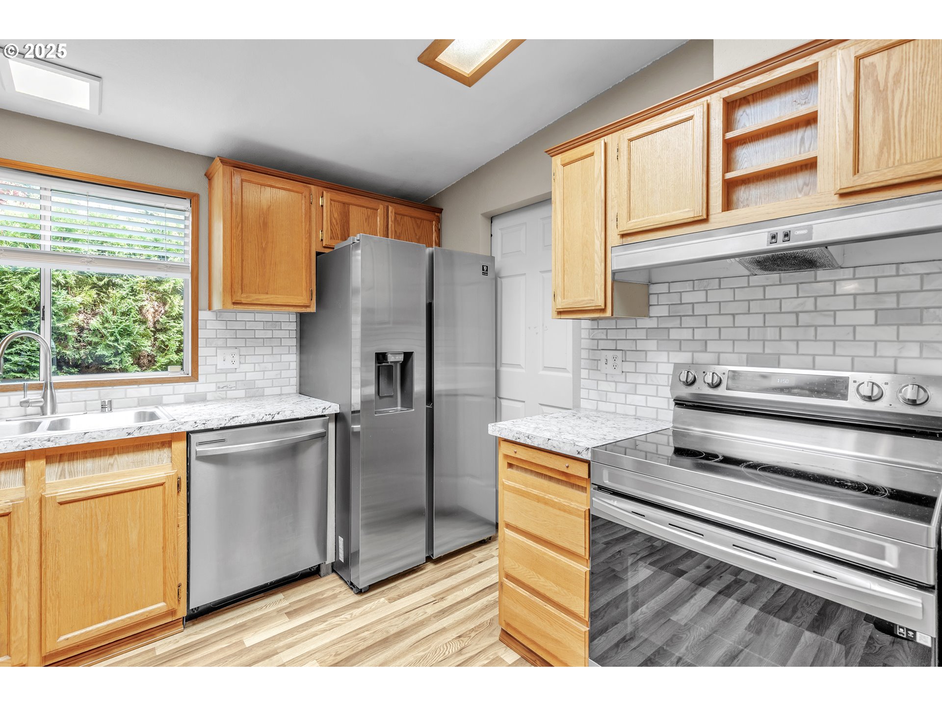 5701 Northeast St Johns Road, Unit 4 Vancouver, WA 98661 - Photo 8 of 28 a kitchen with stainless steel appliances granite countertop a stove a sink and a refrigerator