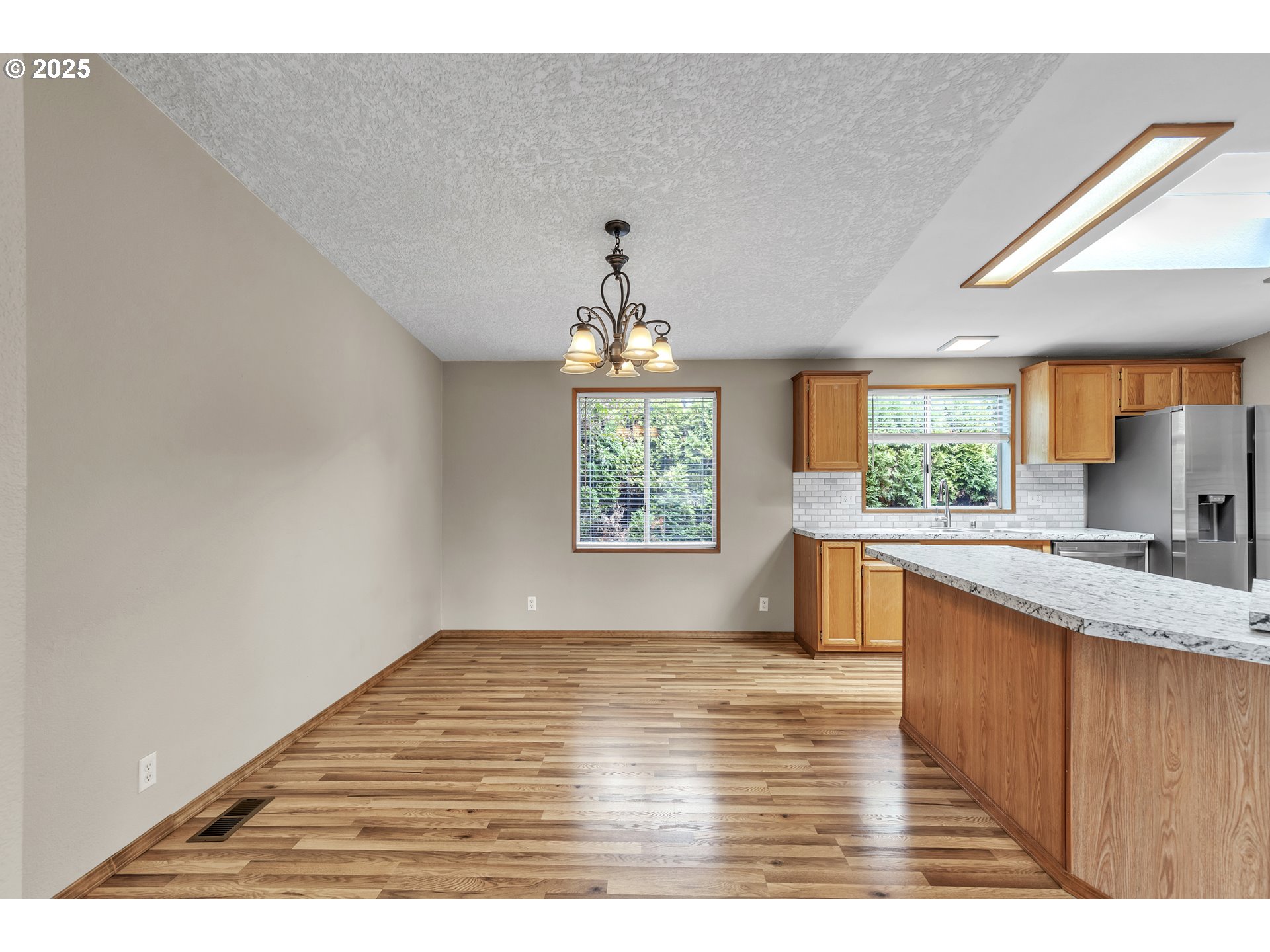 5701 Northeast St Johns Road, Unit 4 Vancouver, WA 98661 - Photo 10 of 28 a kitchen with kitchen island granite countertop a sink window and cabinets