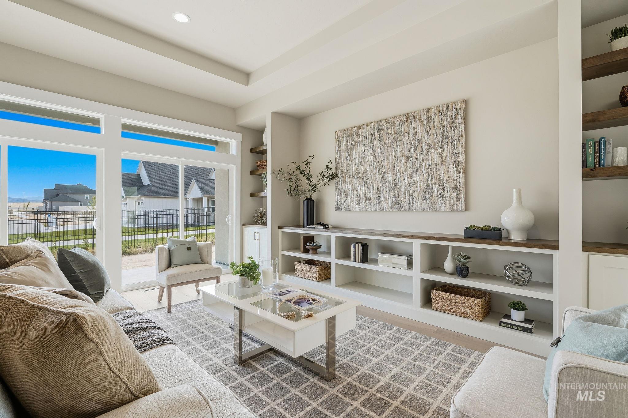 470 South Radiator Way Boise, ID 83716 - Photo 6 of 50 Built-in shelving and cabinetry with wood-finish countertops, recessed lighting, a tray ceiling, and sliding glass doors opening to an outdoor patio