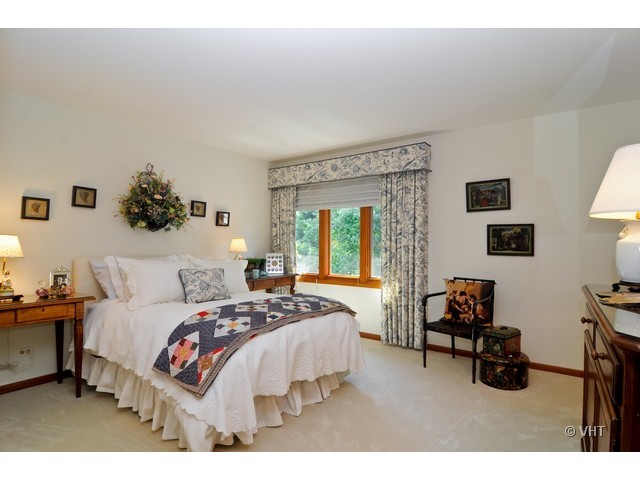 1507 Appleby Road Inverness, IL 60067 - Photo 17 of 25 a bedroom with a bed a couch and dresser
