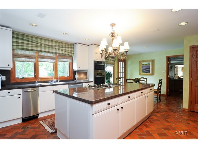 1507 Appleby Road Inverness, IL 60067 - Photo 6 of 25 a large kitchen with kitchen island granite countertop a sink and a white cabinets