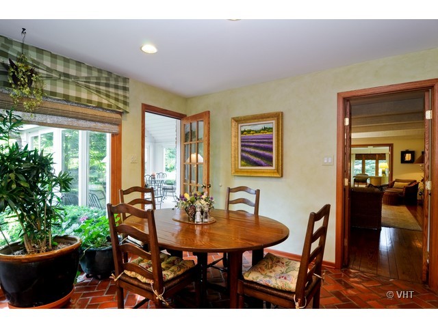 1507 Appleby Road Inverness, IL 60067 - Photo 7 of 25 a view of a dining room with furniture and a potted plant