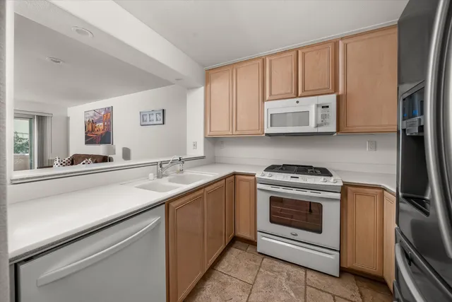 a kitchen with a sink stove and microwave