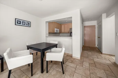 a view of a livingroom with furniture and a table in it