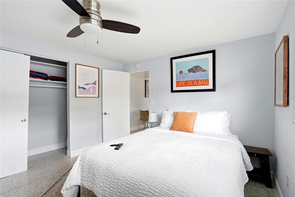 2311 Bay Boulevard Indian Rocks Beach, FL 33785 - Photo 29 of 80 a bedroom with a large bed and a chandelier