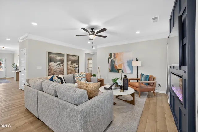 a living room with furniture and a chandelier