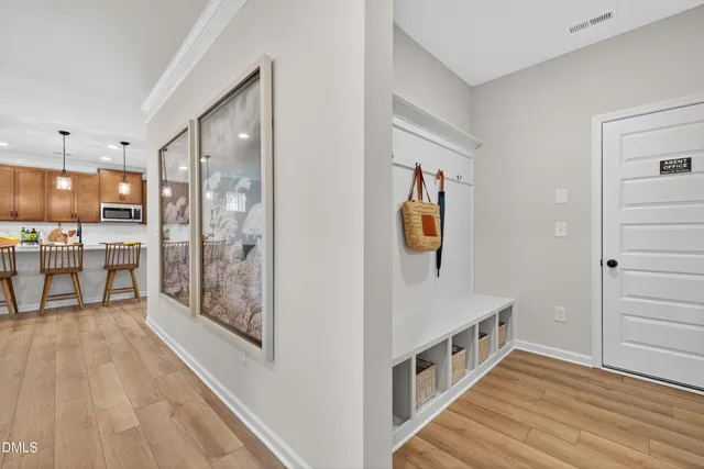 a view of a hallway with wooden floor and staircase