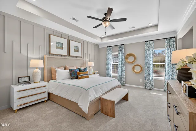 a bedroom with a bed couch and flat tv screen