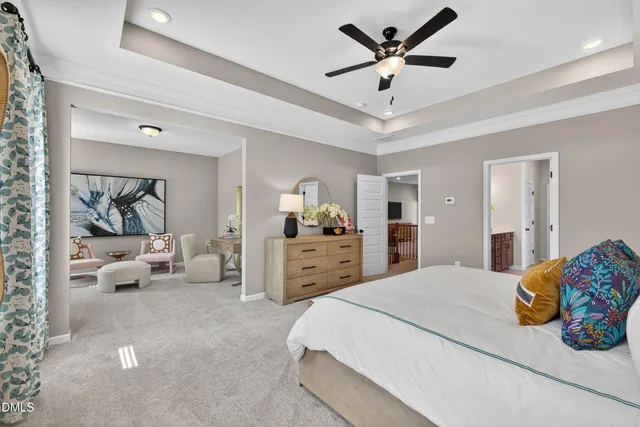 a bedroom with a bed and ceiling fan