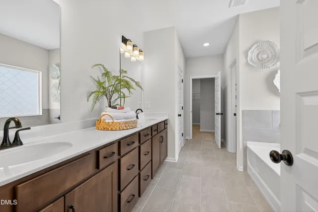 a bathroom with a sink a mirror and shower