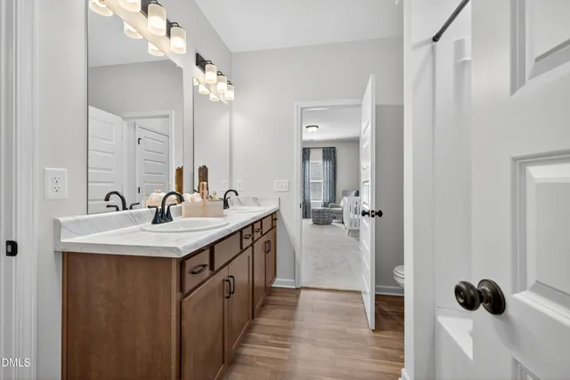 a bathroom with a sink a mirror and a shower