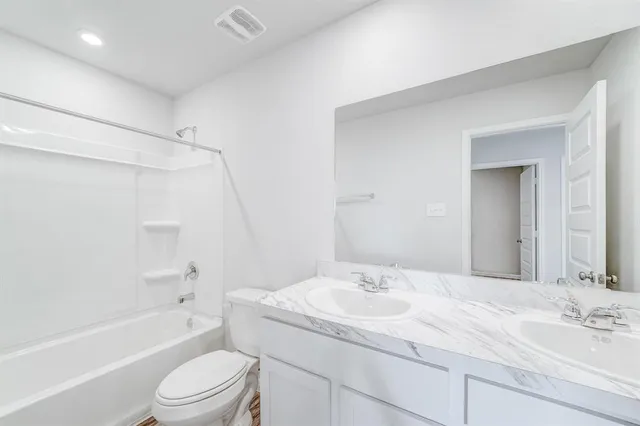 a bathroom with a sink a toilet and bathtub