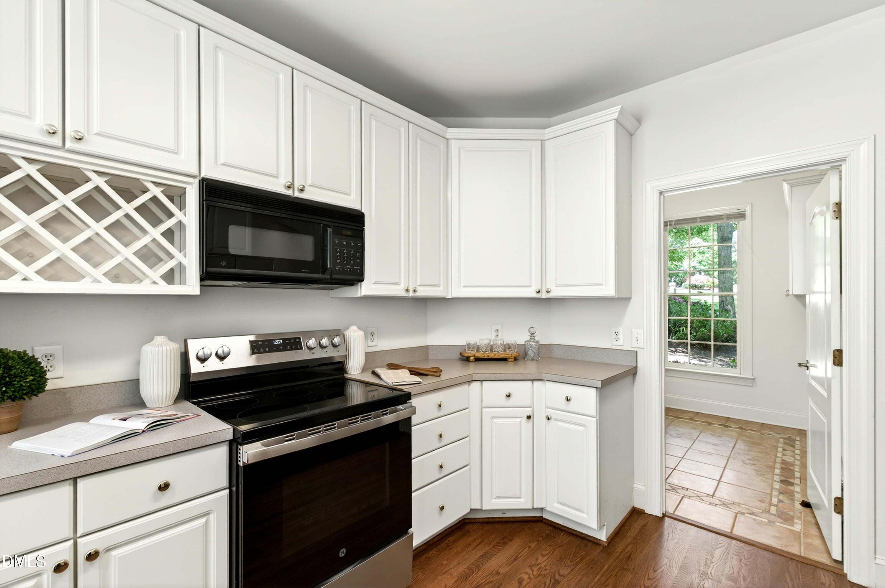 2721 Glassman Lane Raleigh, NC 27606 - Photo 32 of 74 a kitchen with stainless steel appliances granite countertop a sink a stove a microwave and cabinets