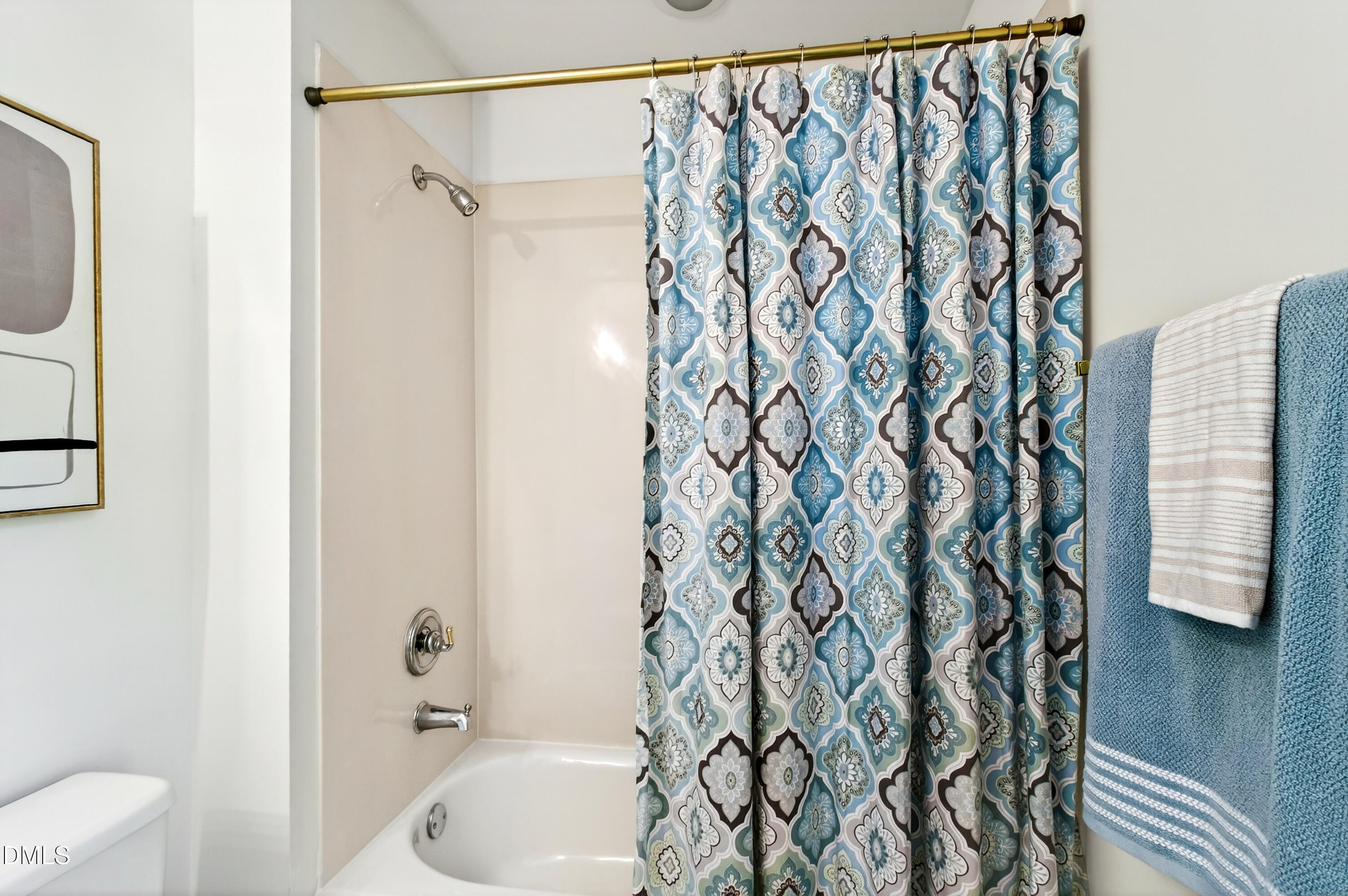 2721 Glassman Lane Raleigh, NC 27606 - Photo 58 of 74 a bathroom with a bathtub and shower curtain