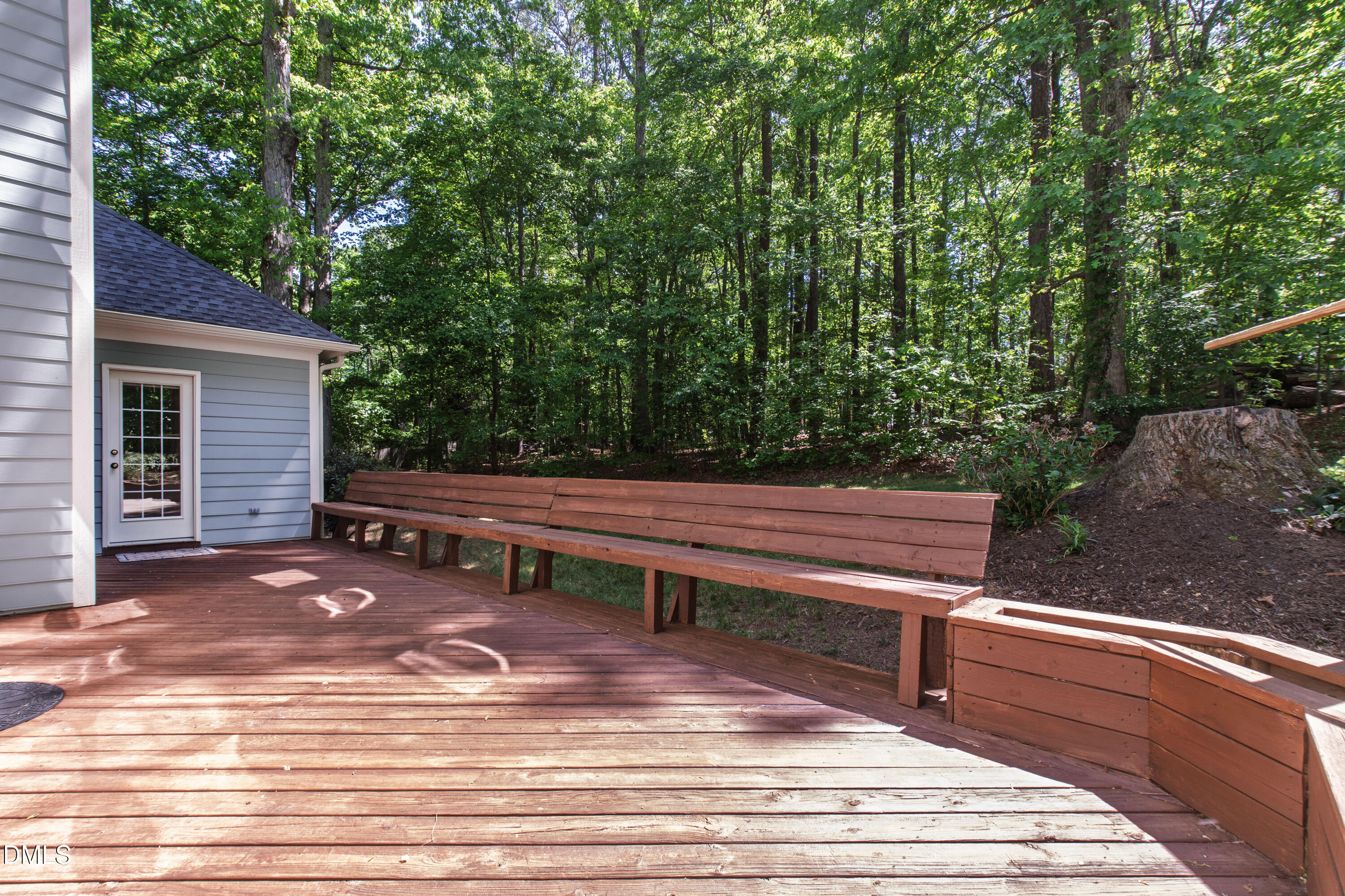 2721 Glassman Lane Raleigh, NC 27606 - Photo 60 of 74 a backyard of a house with wooden floor and outdoor seating