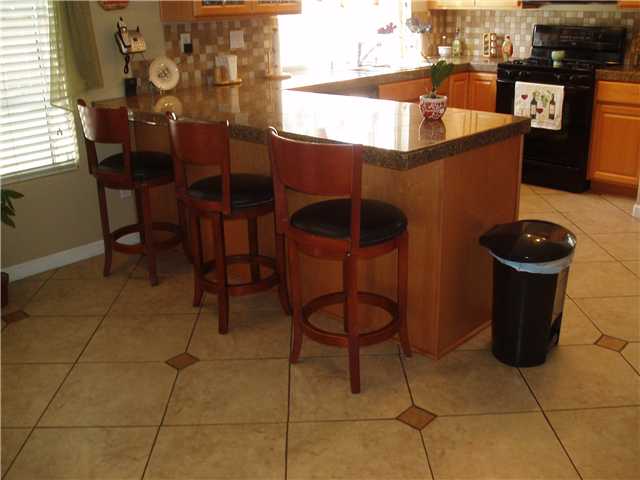 660 Montage Road Oceanside, CA 92057 - Photo 11 of 24 Kitchen with Bar Seating Area & Tiled Flooring
