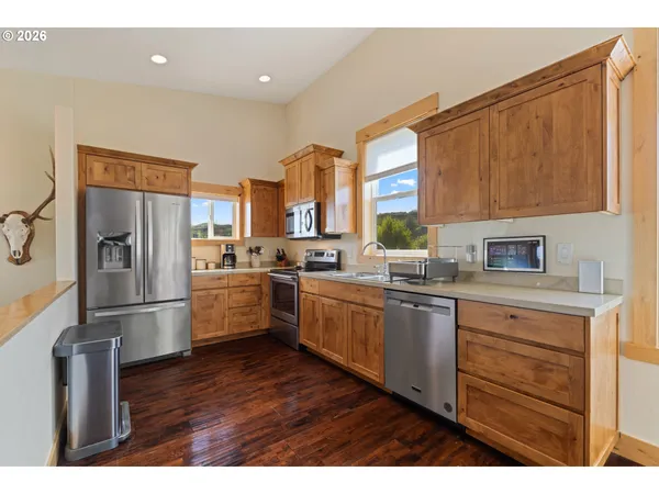 a kitchen with stainless steel appliances a refrigerator sink and cabinets