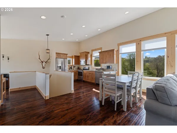 a living room with furniture wooden floor and a floor to ceiling window