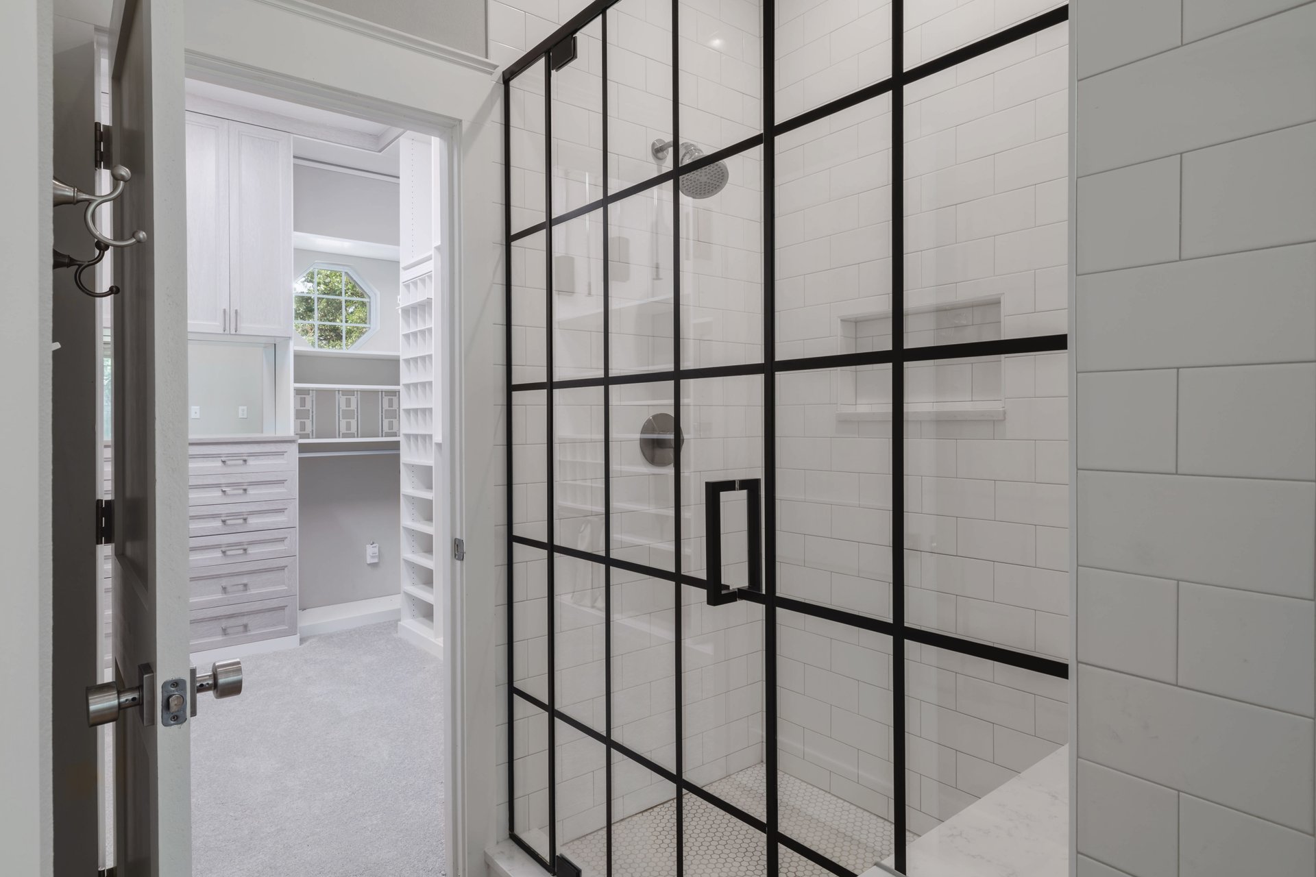 5512 Ballenton Lane Austin, TX 78739 - Photo 23 of 40 A modern grid-patterned glass shower enclosure adjoins a meticulously organized walk-in closet.