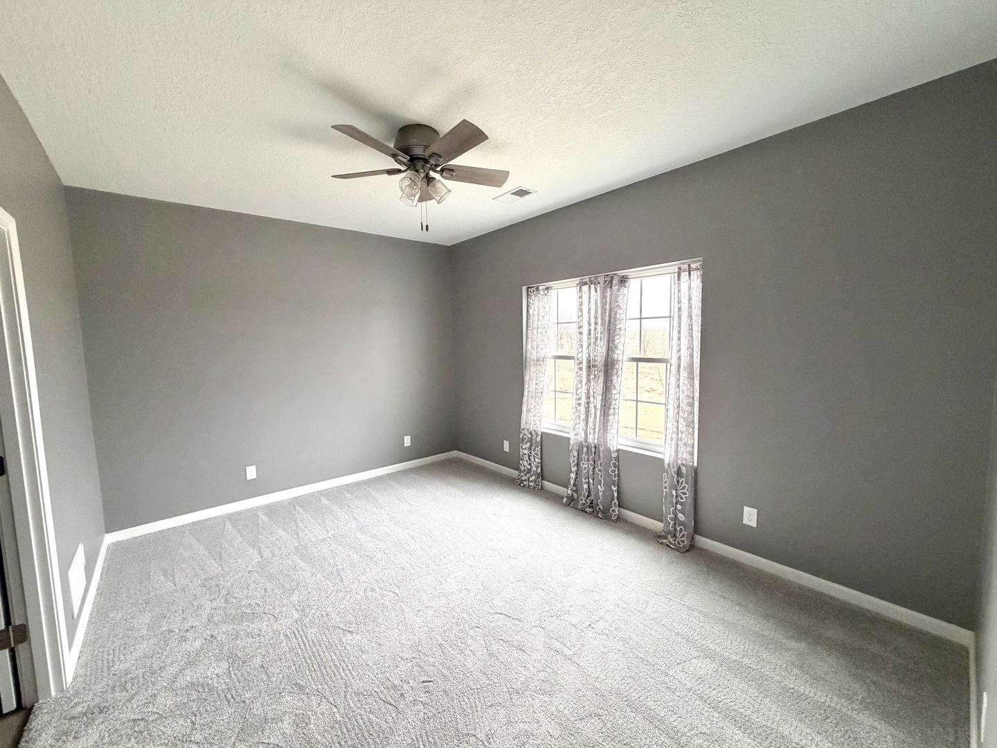 135 Countryview Court Aledo, IL 61231 - Photo 15 of 20 wooden floor in an empty room with a window