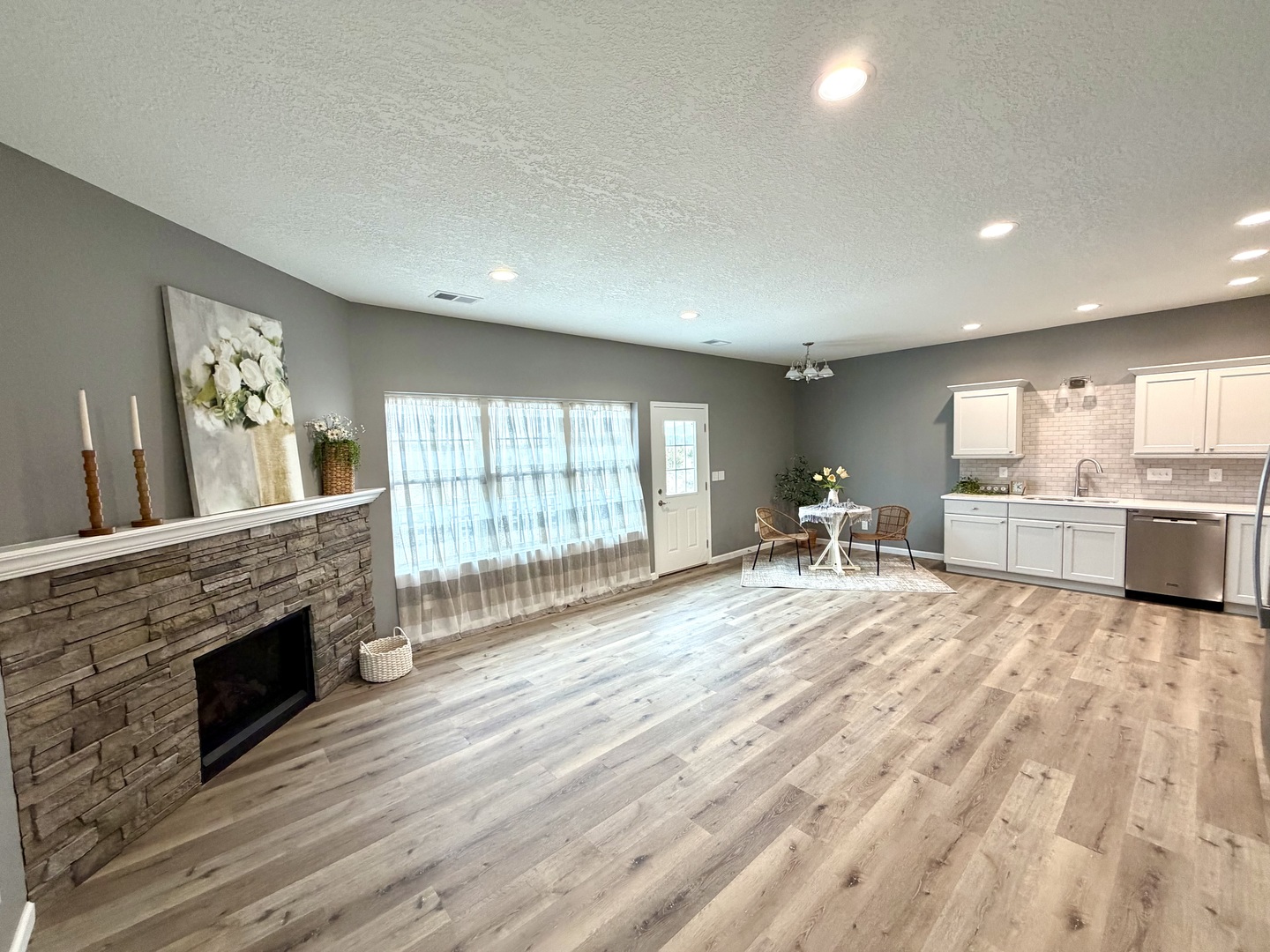 135 Countryview Court Aledo, IL 61231 - Photo 3 of 20 a large white kitchen with wooden floors and a fireplace