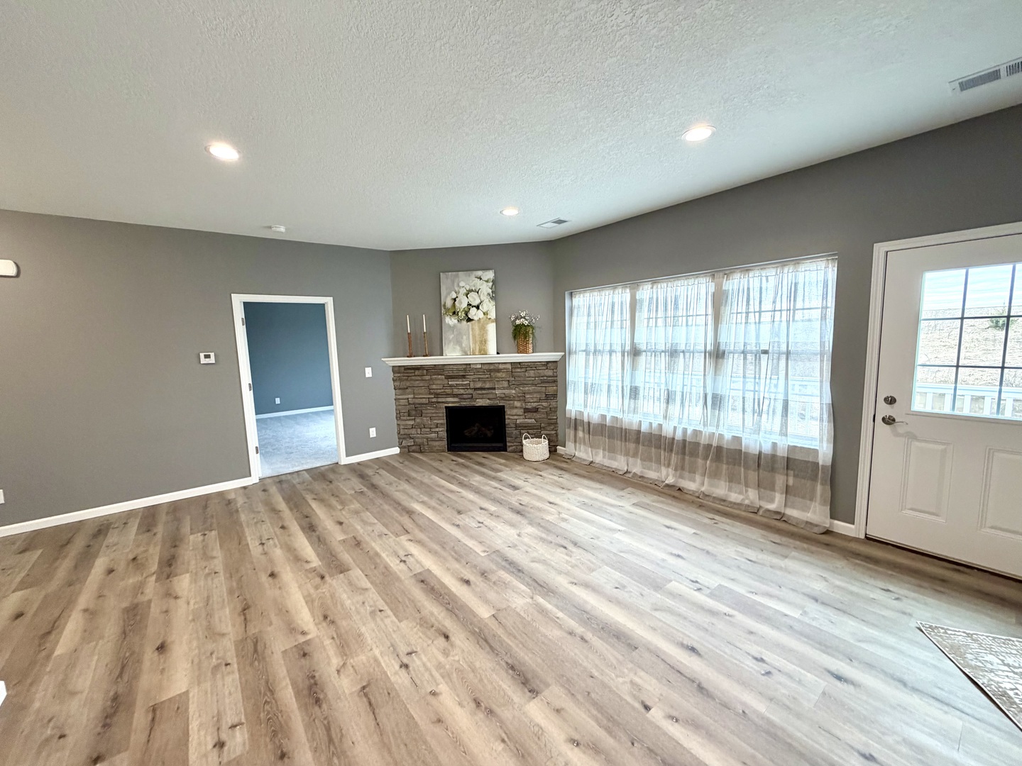 135 Countryview Court Aledo, IL 61231 - Photo 4 of 20 a view of empty room with wooden floor and fireplace