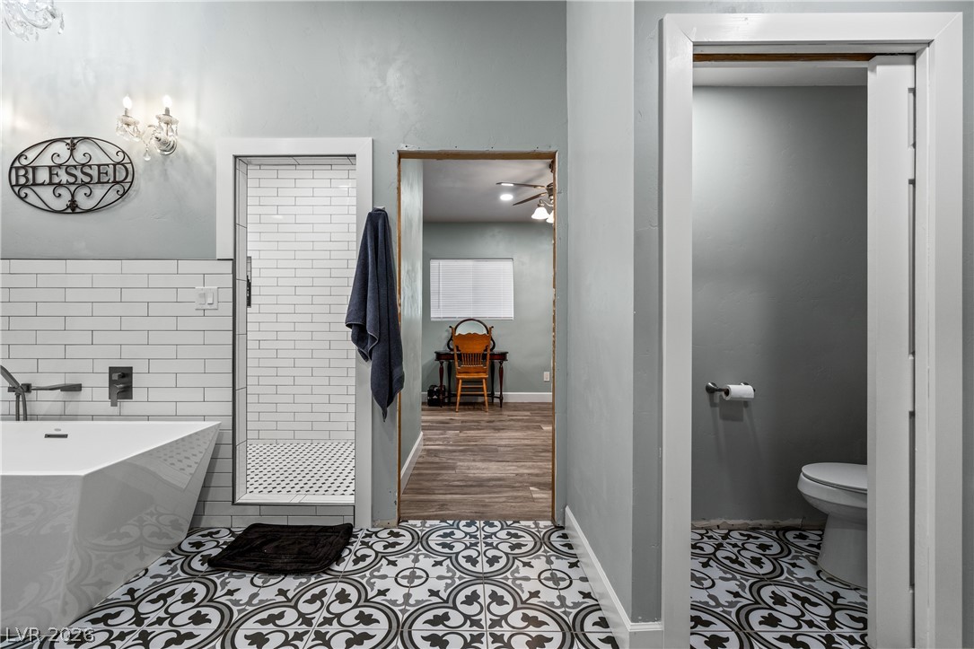 750 Leming Avenue Overton, NV 89040 - Photo 36 of 82 This bathroom features unique patterned tile flooring, a modern tub, and a spacious shower.