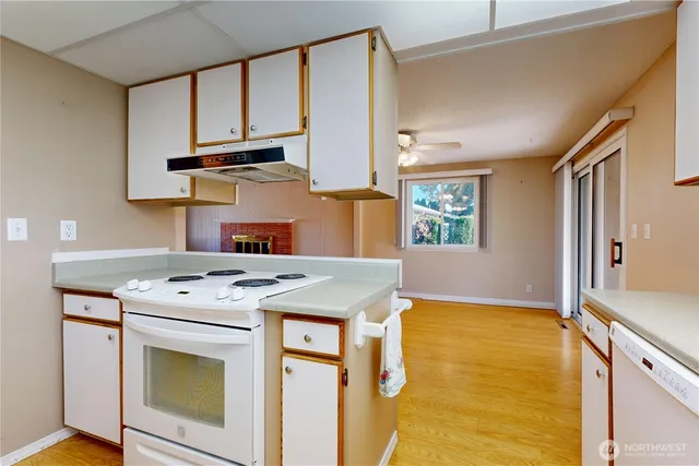 a kitchen with a stove a sink and a refrigerator