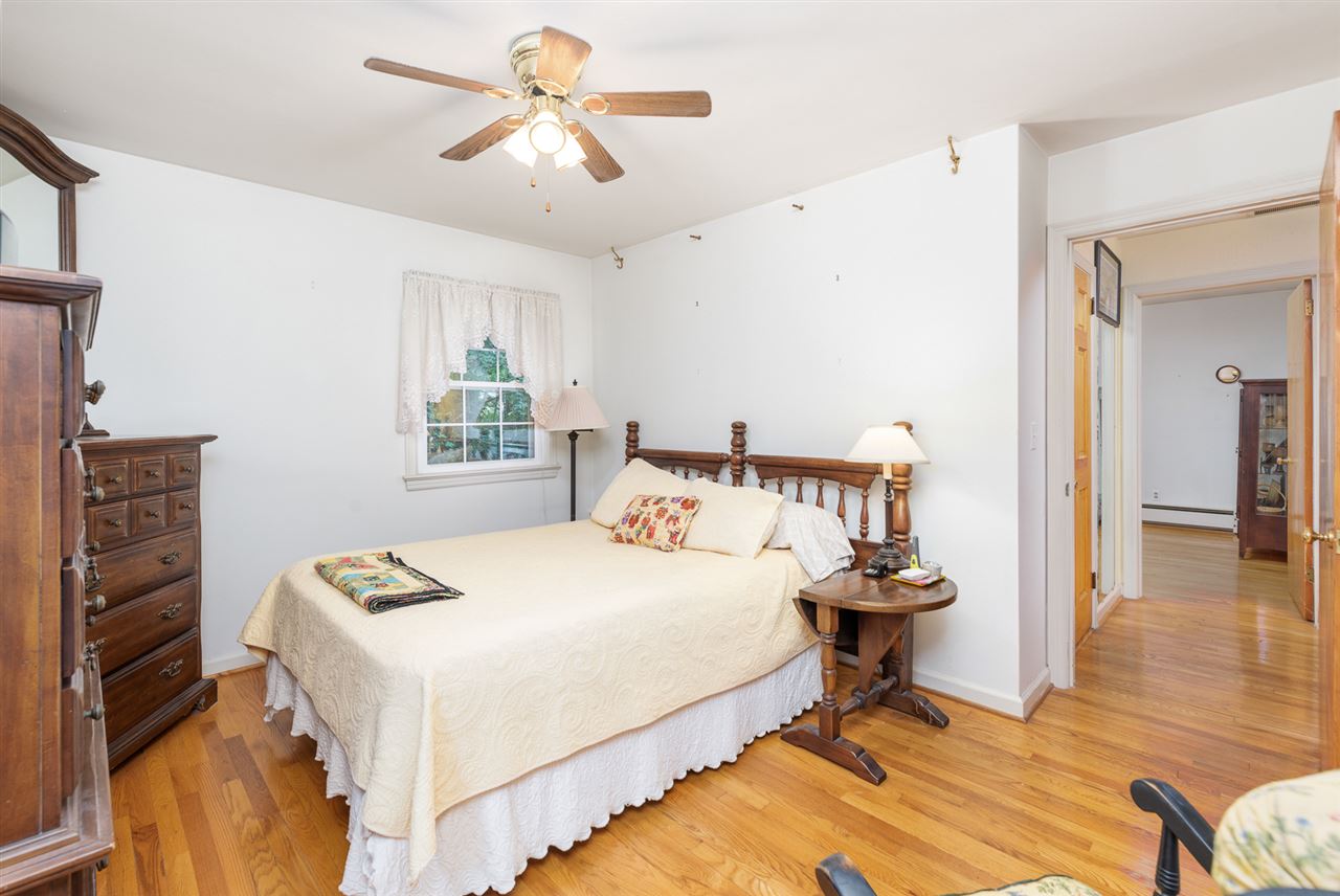 235 Overlook Road Staunton, VA 24401 - Photo 13 of 37 a bedroom with a bed and a chandelier