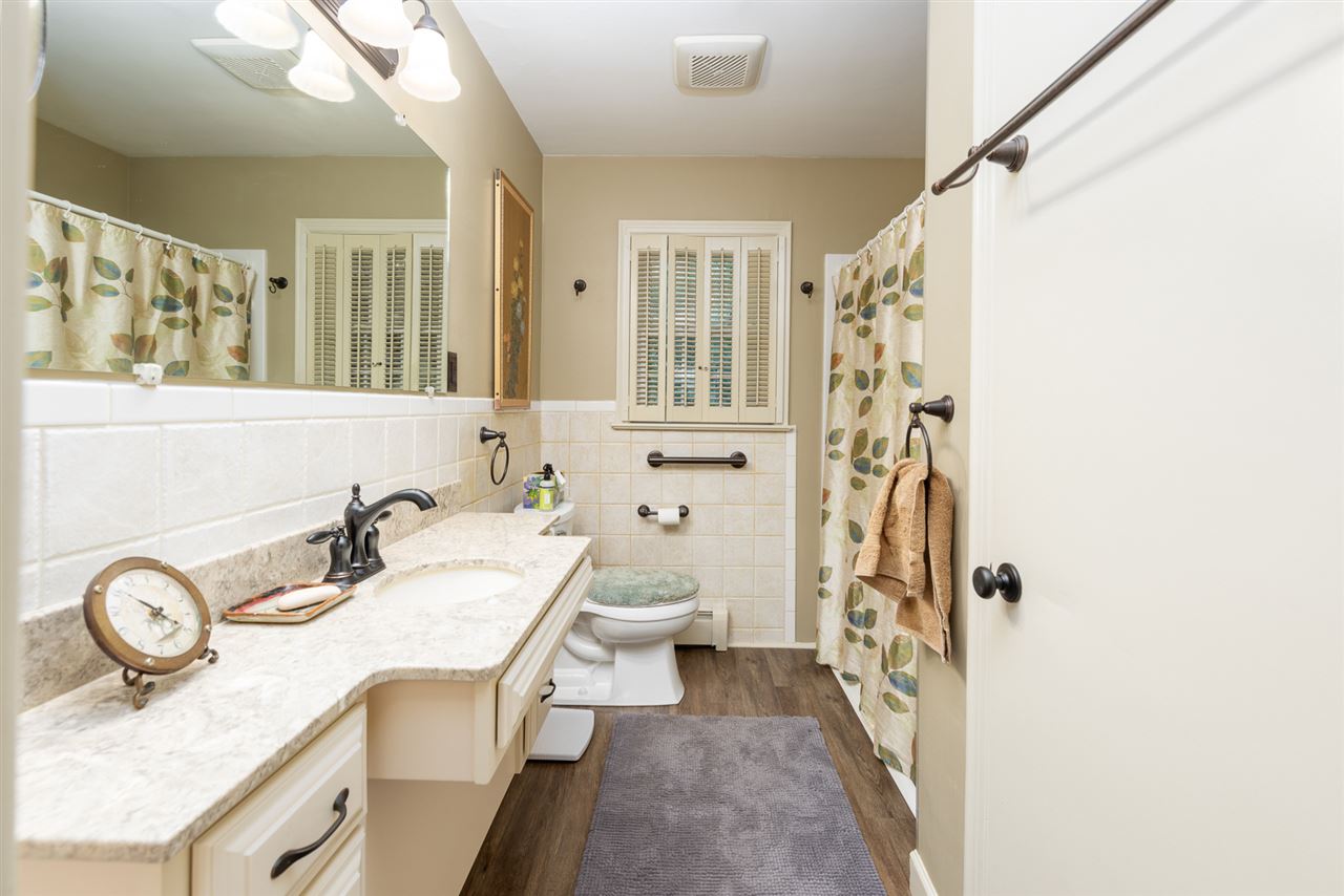 235 Overlook Road Staunton, VA 24401 - Photo 15 of 37 a bathroom with a granite countertop sink a mirror a vanity and a shower