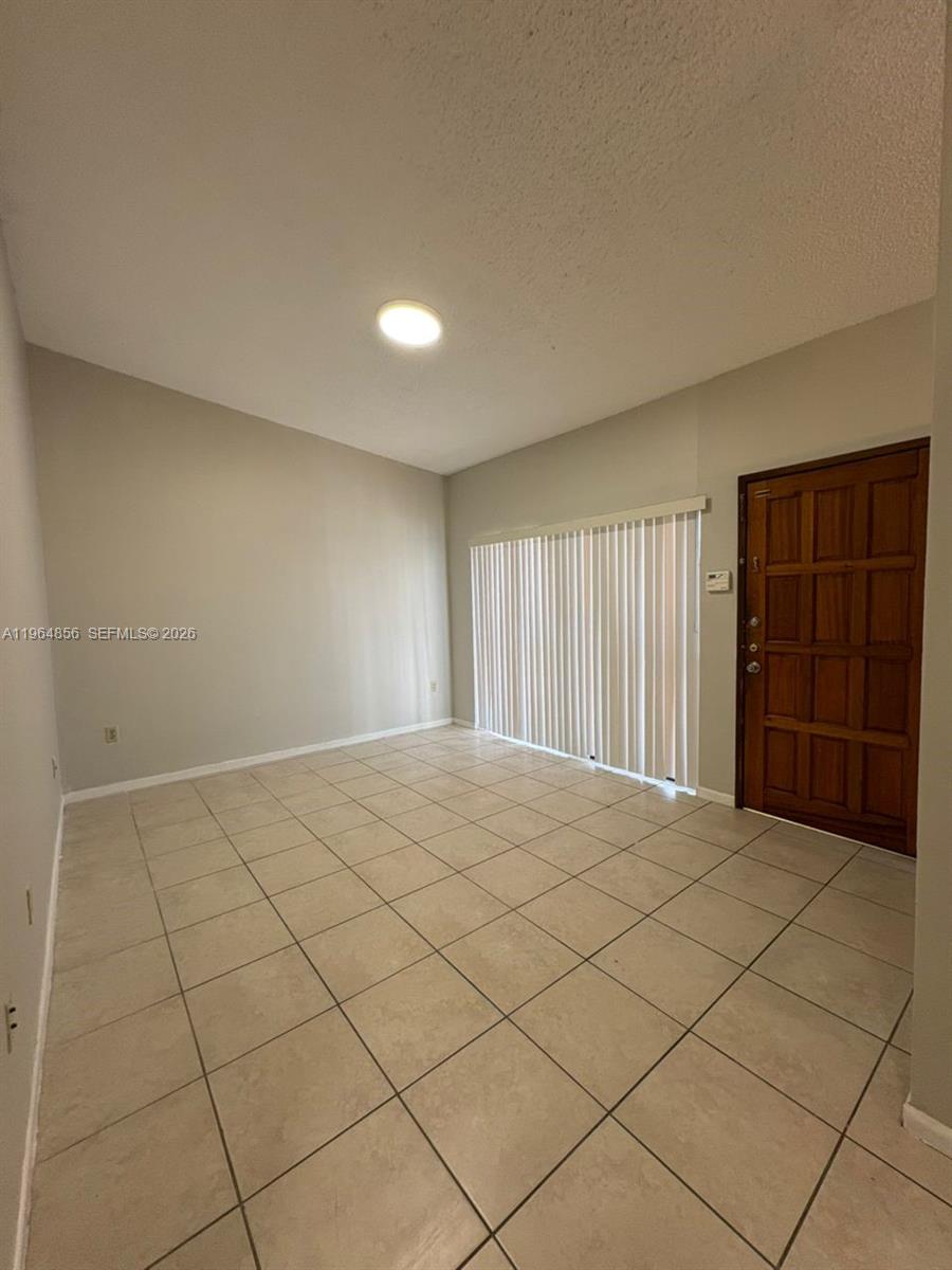 7440 Southwest 153rd Court, Unit 2014 Miami, FL 33193 - Photo 12 of 25 a view of an empty room and window