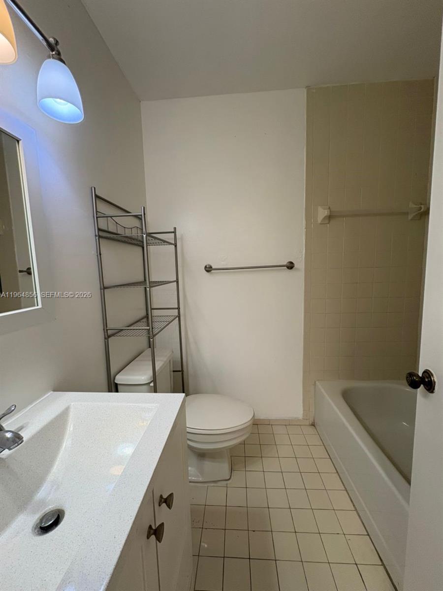 7440 Southwest 153rd Court, Unit 2014 Miami, FL 33193 - Photo 17 of 25 a bathroom with a sink a toilet and shower