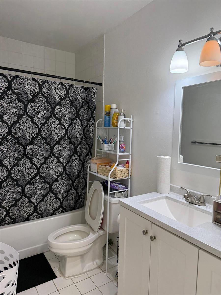 7440 Southwest 153rd Court, Unit 2014 Miami, FL 33193 - Photo 22 of 25 a bathroom with a sink toilet and shower