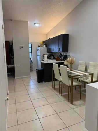 a kitchen with stainless steel appliances a stove a sink and a refrigerator