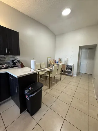 a room with chairs and flat screen tv