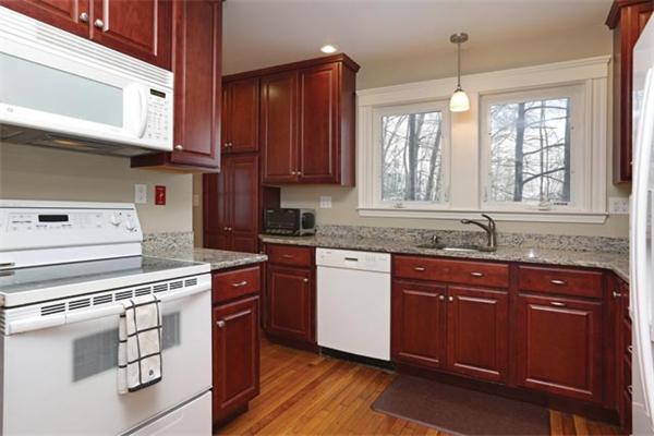 53 Ripley Street, Unit 53 Newton, MA 02459 - Photo 4 of 7 a kitchen with stainless steel appliances granite countertop a sink a stove cabinets and wooden floor
