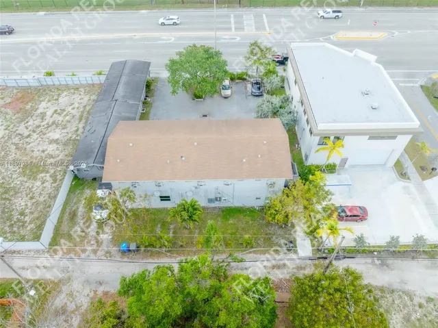 an aerial view of a house with a yard and a fountain