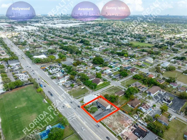 an aerial view of residential house with an outdoor space and lakeside