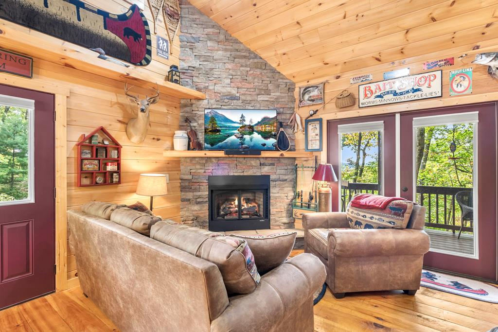 205 Copper Mountain Drive Murphy, NC 28906 - Photo 15 of 29 a living room with furniture a fireplace and a floor to ceiling window
