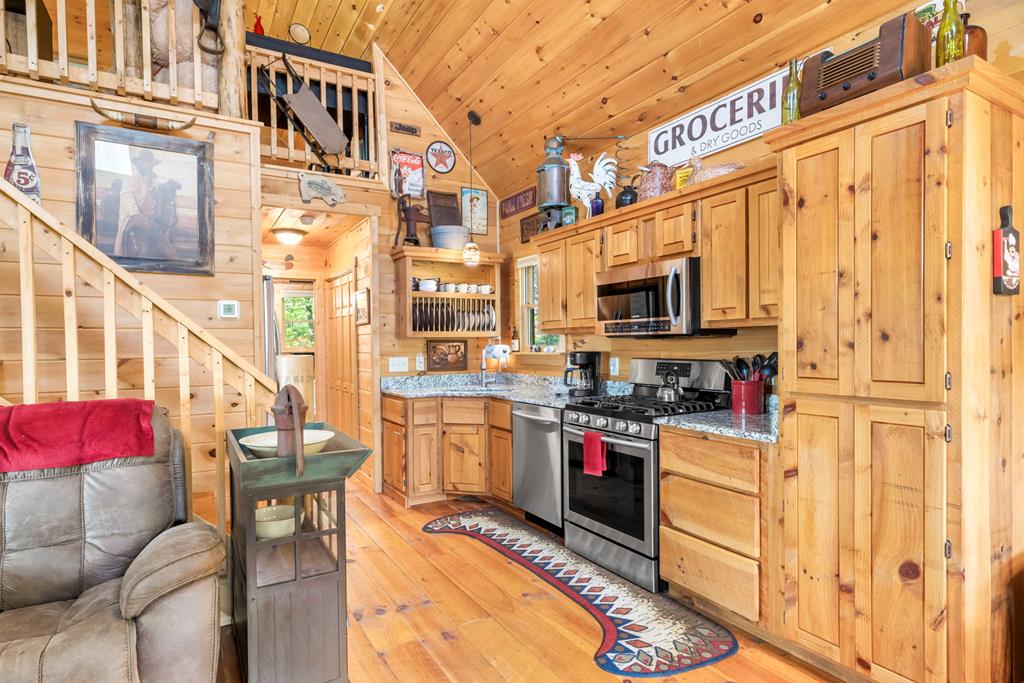 205 Copper Mountain Drive Murphy, NC 28906 - Photo 21 of 29 a kitchen with stainless steel appliances kitchen island granite countertop a stove and a refrigerator