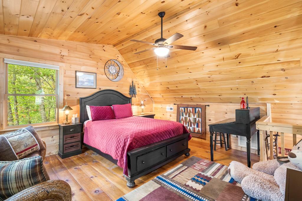 205 Copper Mountain Drive Murphy, NC 28906 - Photo 28 of 29 a spacious bedroom with a bed and wooden floor